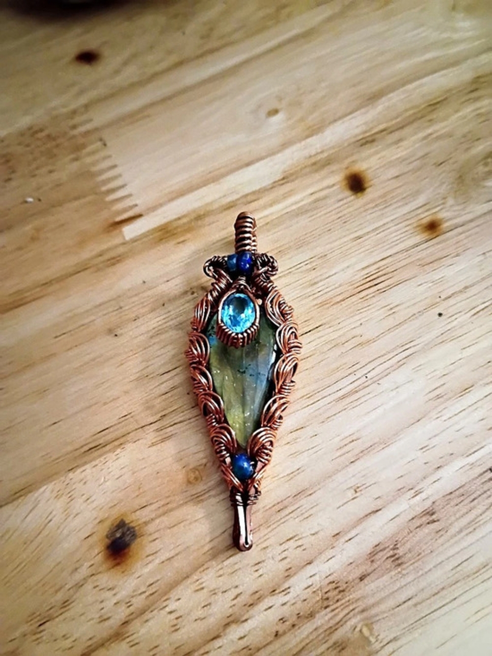 Wire-Wrapped Labrodite Accented By Blue Topaz And A Few Small Smoked Opal Beads